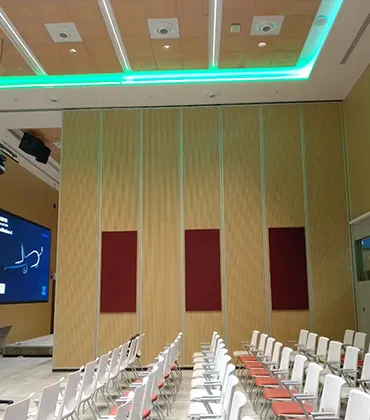 Operable acoustic wood partition wall installed in a large conference room.